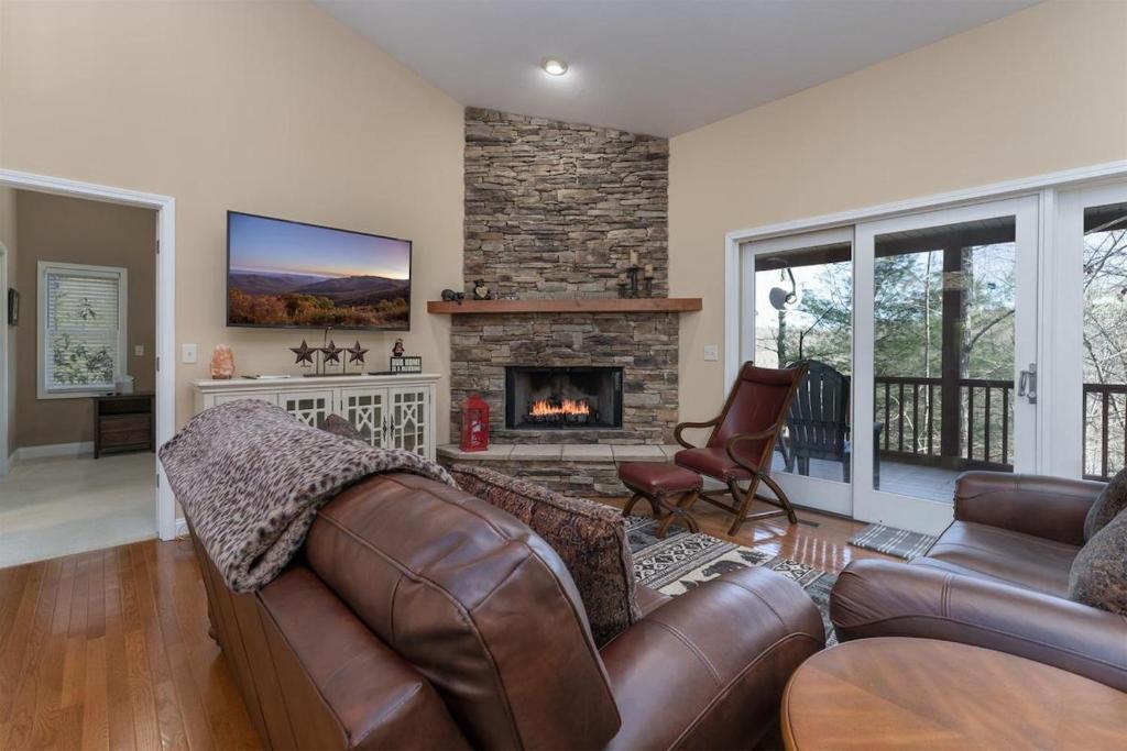 a living room with a couch and a fireplace at Bearly Ruffin It · Bearly Ruffin It in Connestee Falls in Brevard