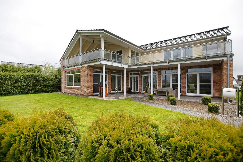a large brick house with a large yard at Haus Eiderblick in Horst
