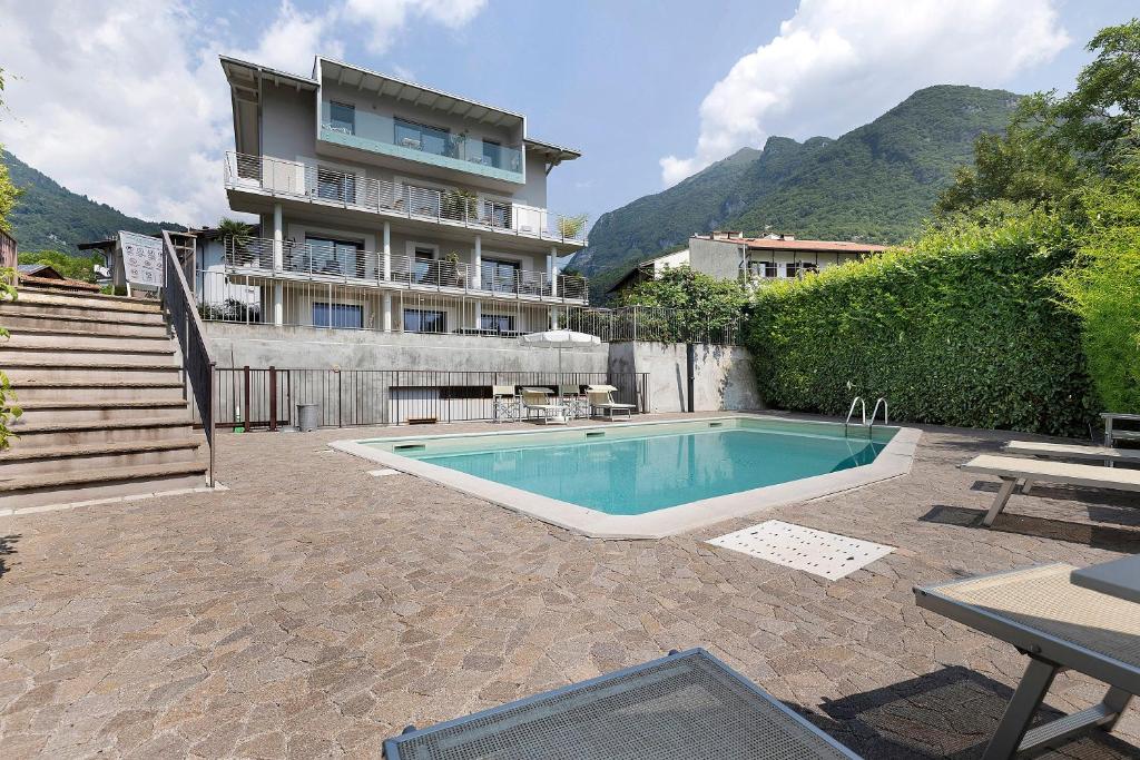 a swimming pool in front of a building at Eco Del Garda Bnb in Tenno
