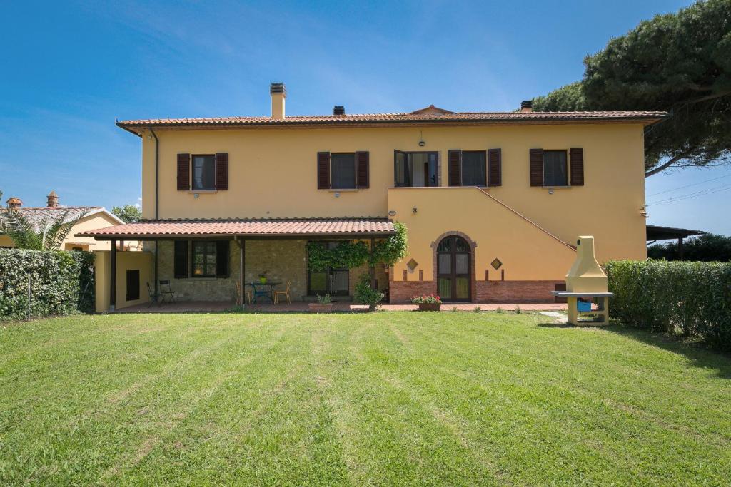 a large house with a lawn in front of it at Podere Nuti - 2 Beloro in Cecina