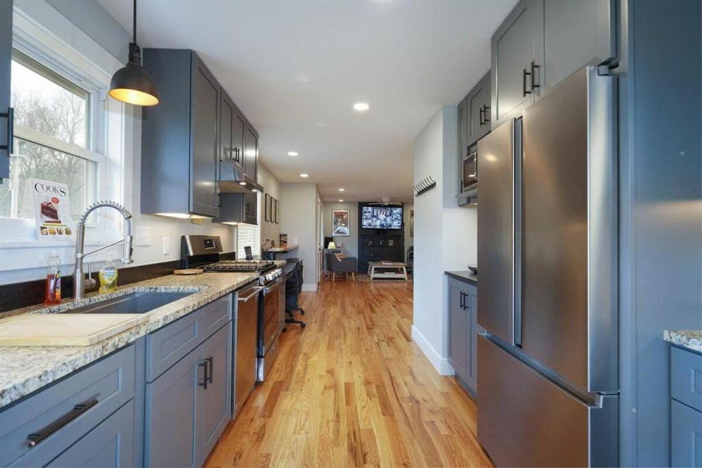 a kitchen with blue cabinets and stainless steel appliances at JB`s Place · JB`s Place in Brevard