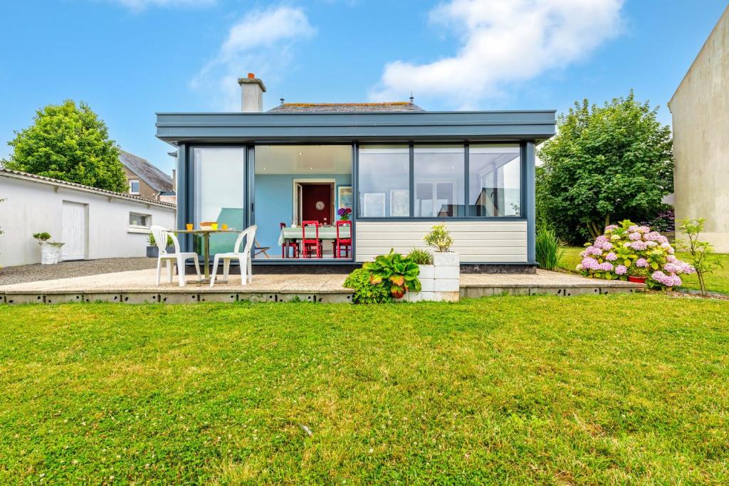 a home with a conservatory with a lawn at Maison 4 pers à 5kms de la plage in Plouider