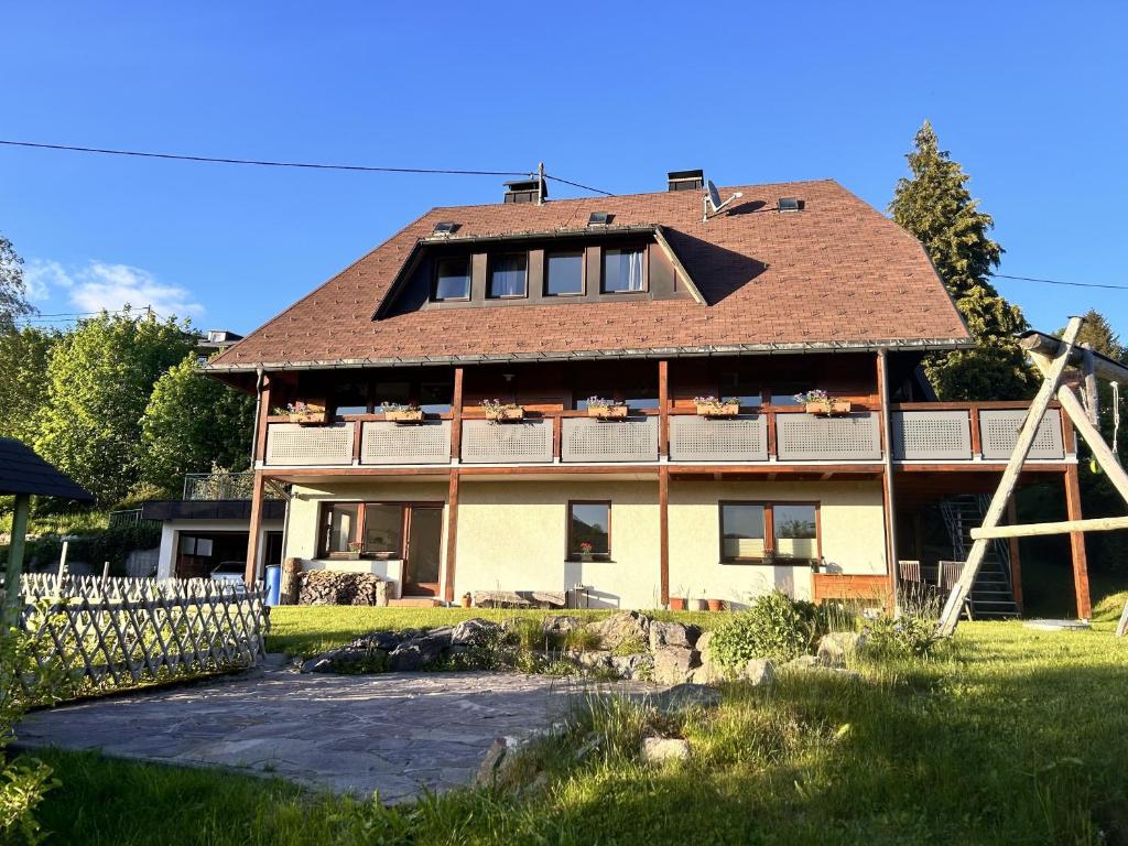 a large house with a gambrel roof at Ferienwohnung Käppeleblick in Bernau im Schwarzwald