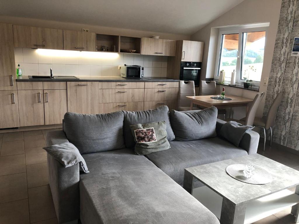 a living room with a couch and a table at Fewo Stremme in Altenlotheim