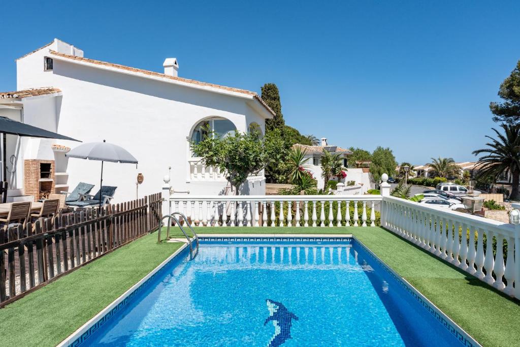 a swimming pool in the backyard of a house at Superbly situated villa 67 in Mijas Costa