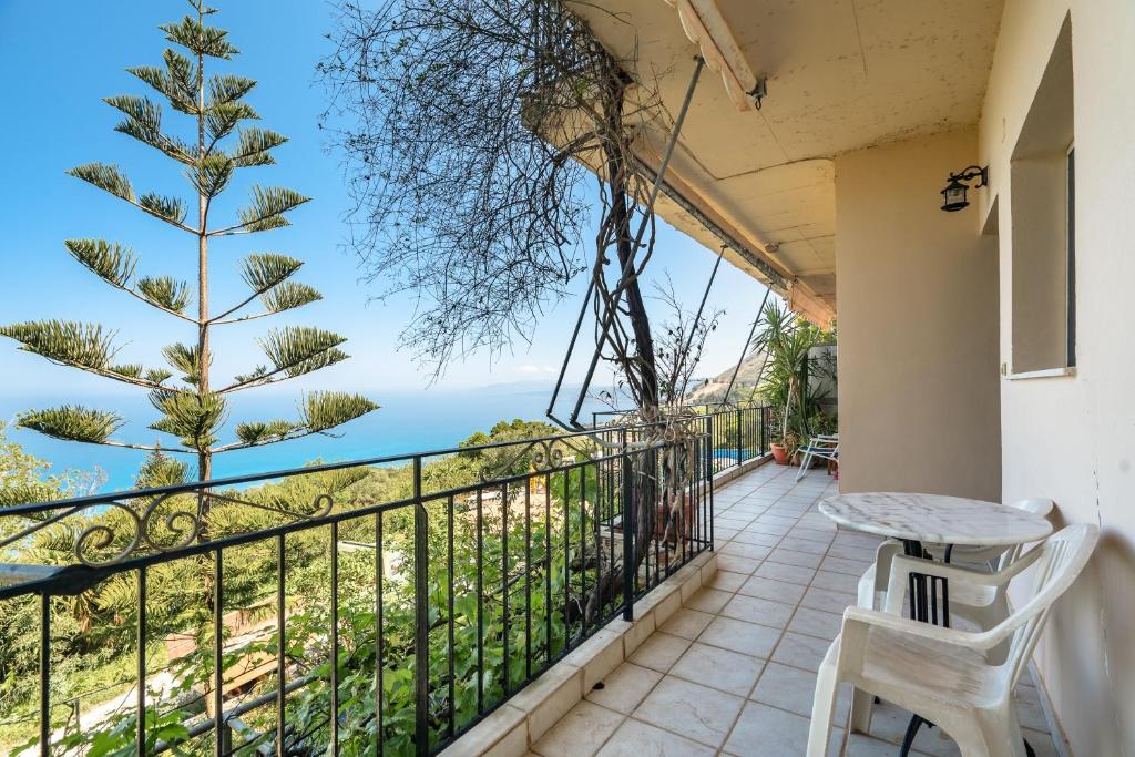 a balcony with a table and a view of the ocean at Vangelis studio 1 in Kefalonia