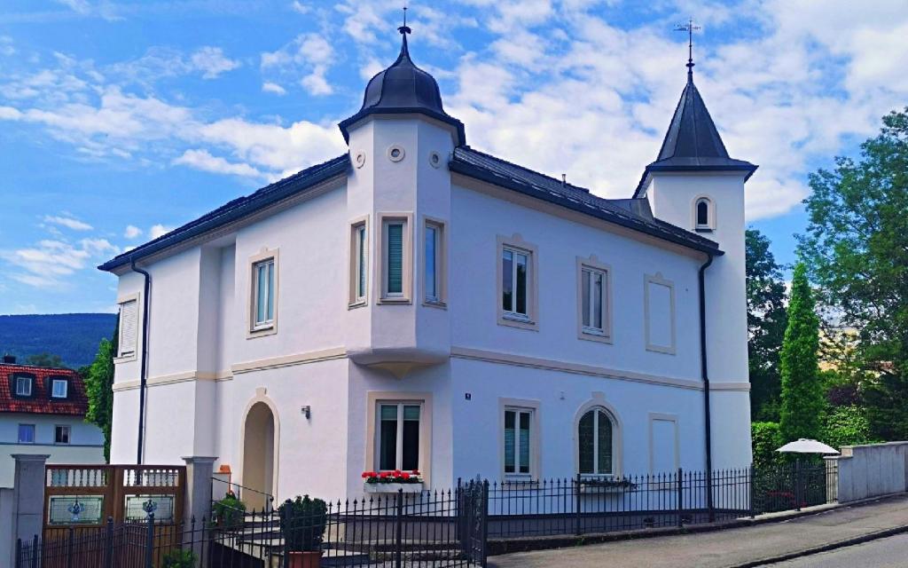 a white building with two towers on top of it at Villa Karlsbach in Teisendorf