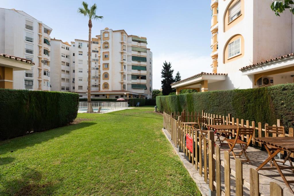 a row of tables and chairs in front of a building at Apartamentos Sealmar Moliere in Málaga