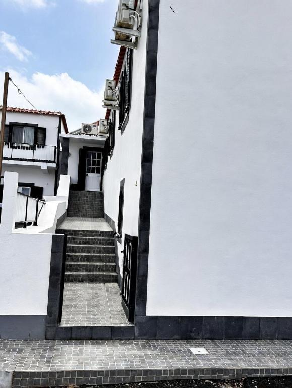 a stairway leading up to a white building at Ocidente House 2 in Santa Cruz das Flores