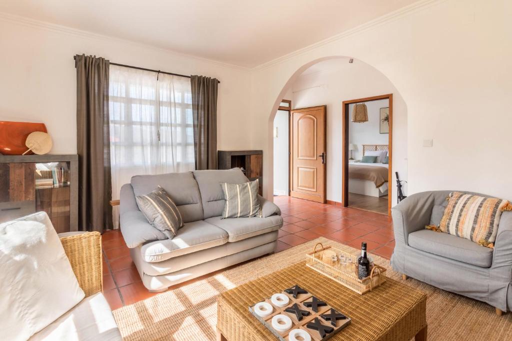a living room with a couch and a table at Casa da Olides - T3 in Santana