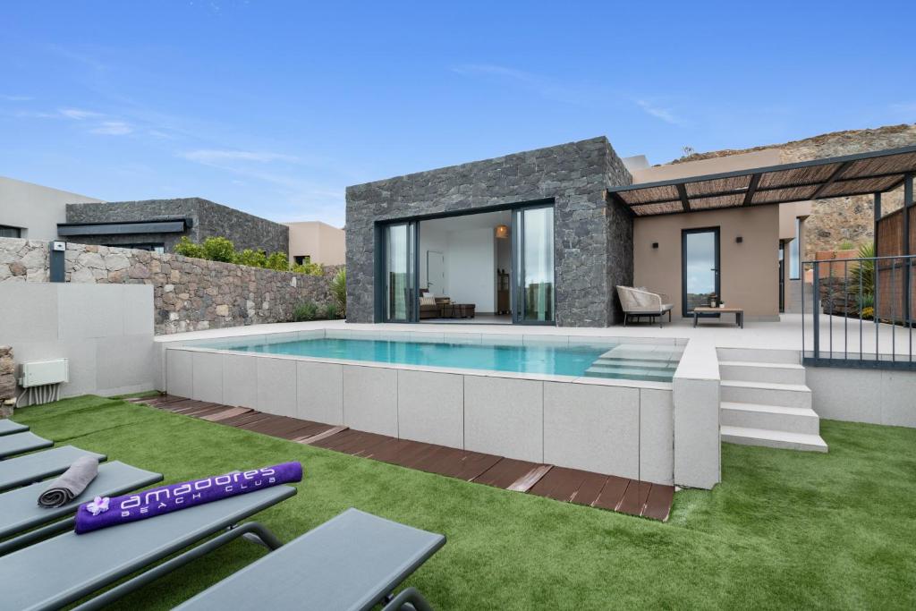 a villa with a swimming pool and a house at Yucas Villa 17 in San Bartolomé