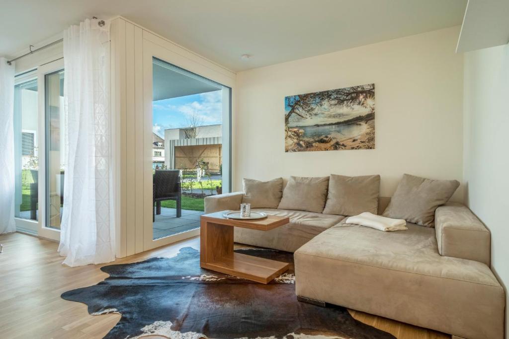a living room with a couch and a table at Sunny Appartment in Bregenz