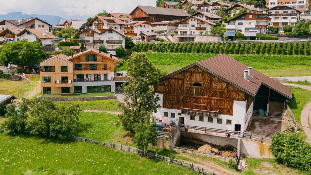 an aerial view of a village with a barn at Moarhof in Meltina