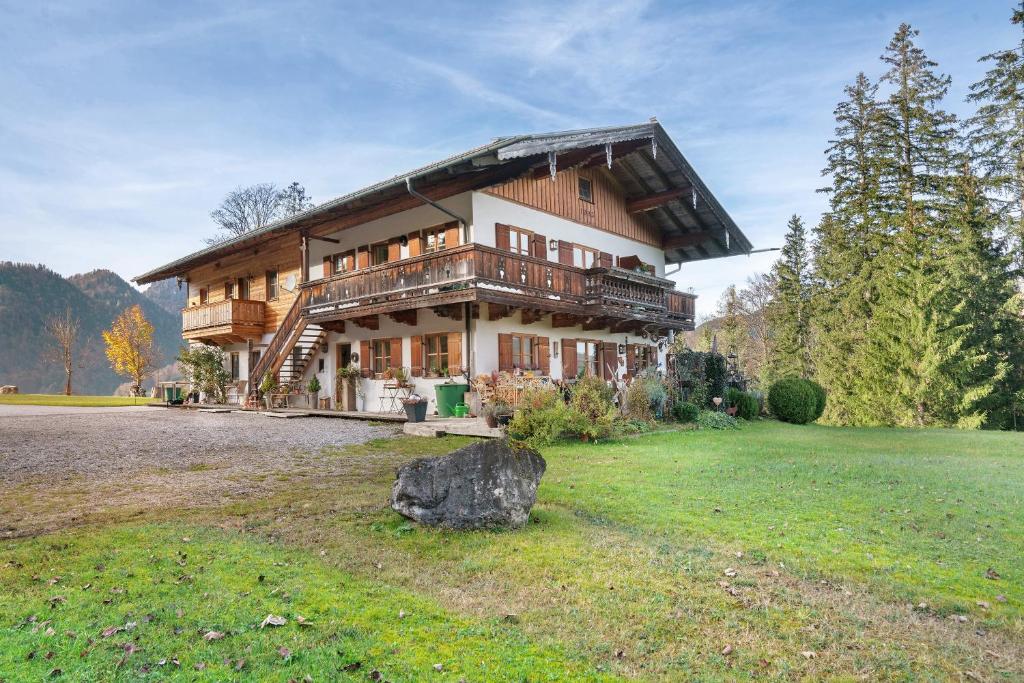 a large wooden house with a large yard at Ferienwohnung Rauschberg in Ruhpolding