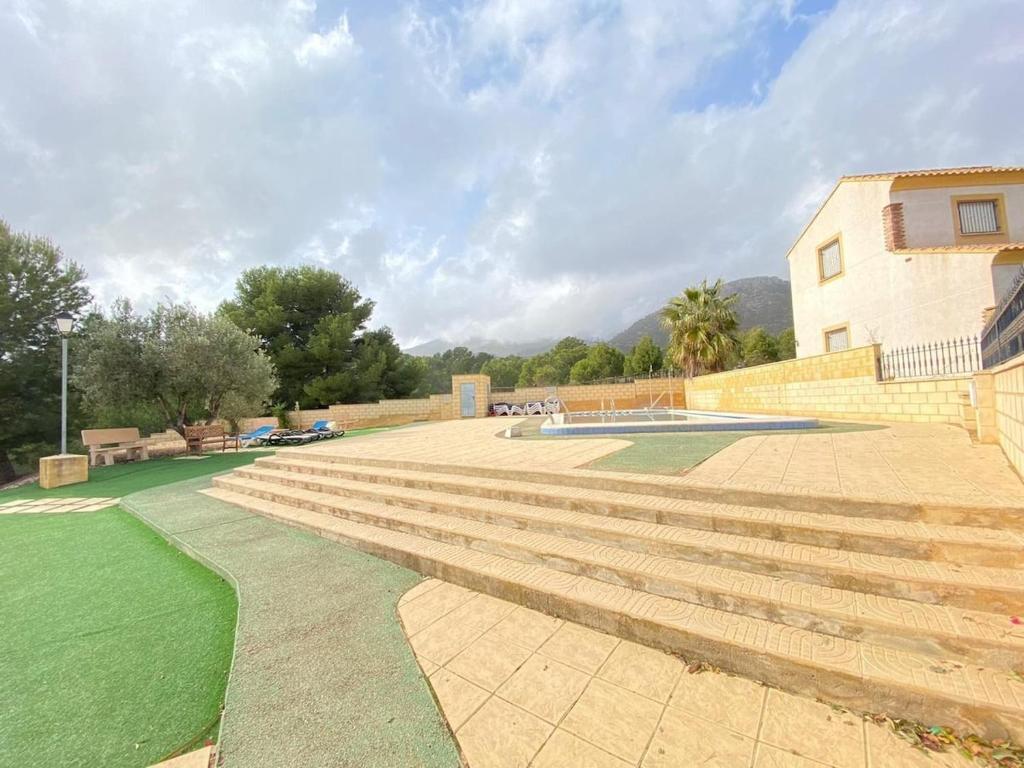 a set of concrete steps next to a building at Alberca La Nucia in Polop