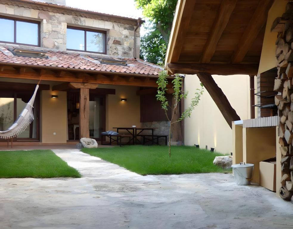 an external view of a house with a patio at Casa Rural Fuentebuena in Matabuena