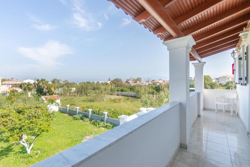 a view from the balcony of a house with a view at Olivea Studio 3 in Acharavi