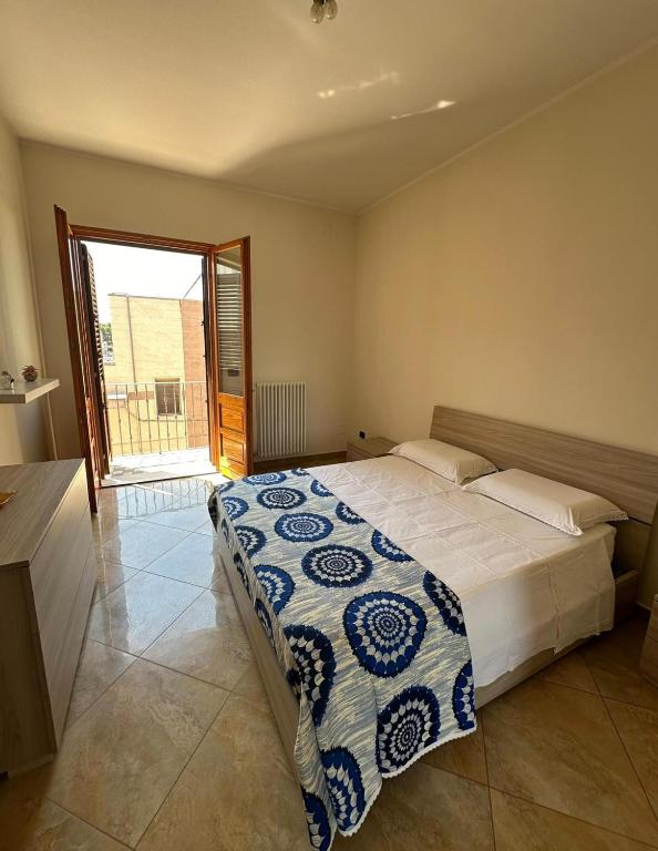 a bedroom with a bed with a blue and white blanket at Da Katia in Arnesano