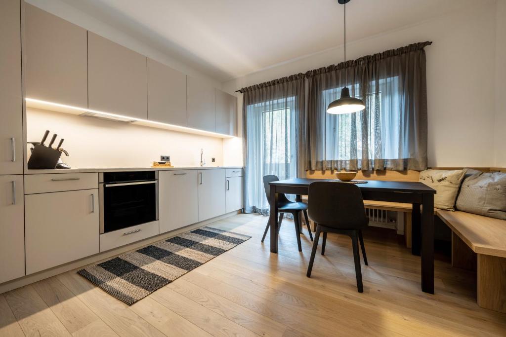 a kitchen with a table and a dining room at Plose 35 in Bressanone