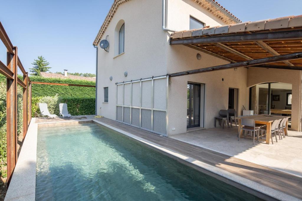 an external view of a house with a swimming pool at Villa Luminières I in Sallelles