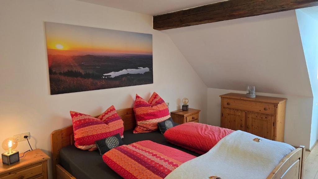 a living room with a couch with colorful pillows at Fewo Gipfelstürmer mit Königscard in Nesselwang