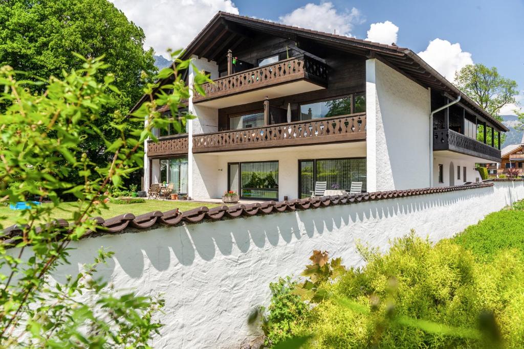 a house with a balcony on top of a wall at Johannas Alm in Garmisch-Partenkirchen