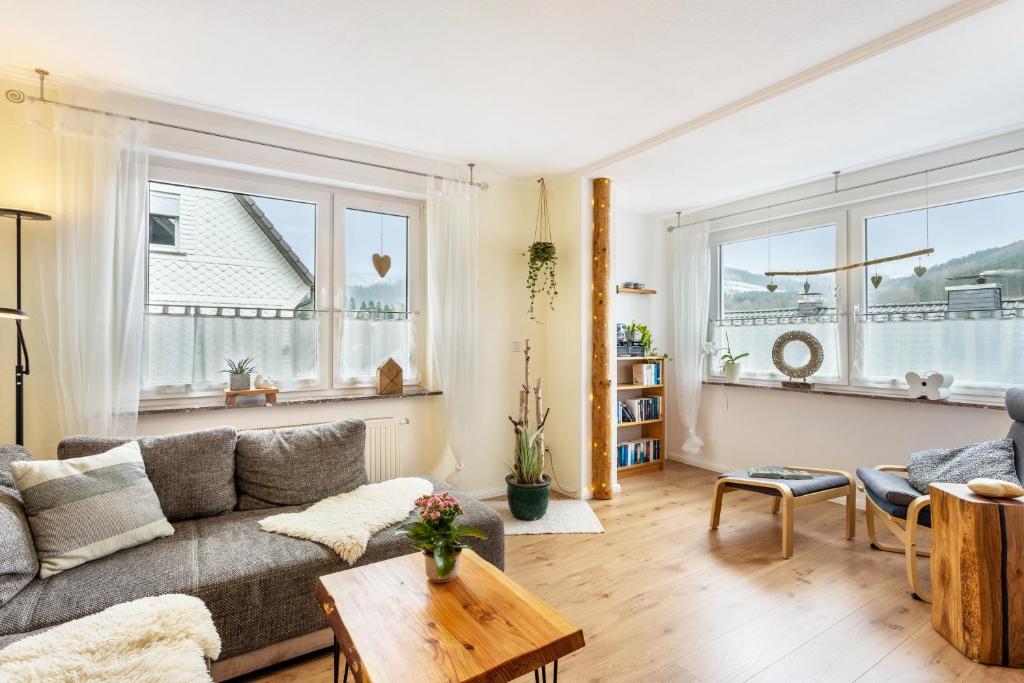 a living room with a couch and a table at Ferienwohnung Richter in Kirchhundem