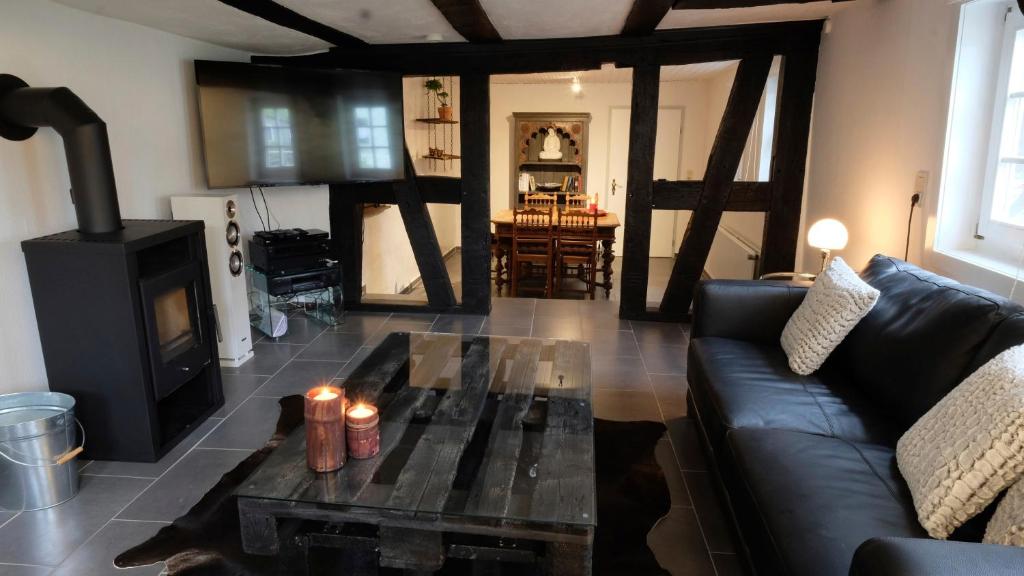 a living room with a couch and a wood stove at Haus Auenland in Groß Felda