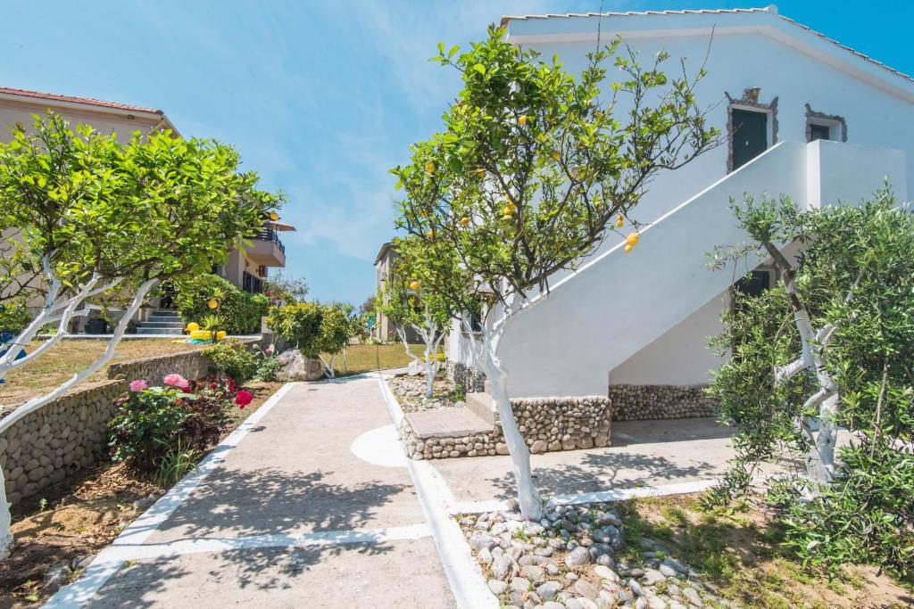 a house with trees in front of it at Mirage Arillas Apartment C in Arillas