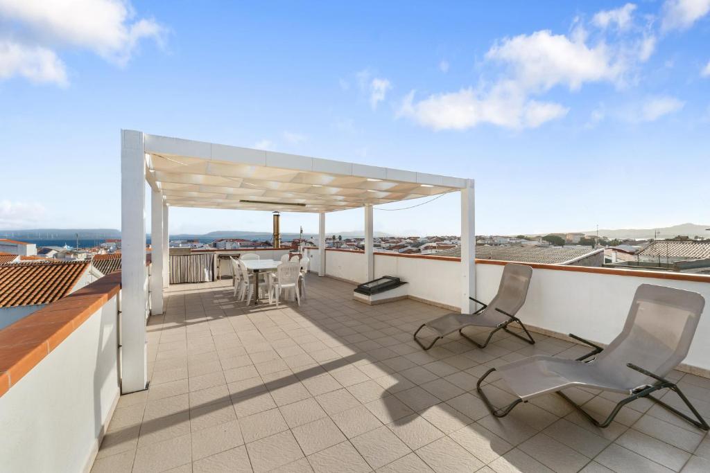 a patio with chairs and a table on a roof at Casa Susanna in Calasetta