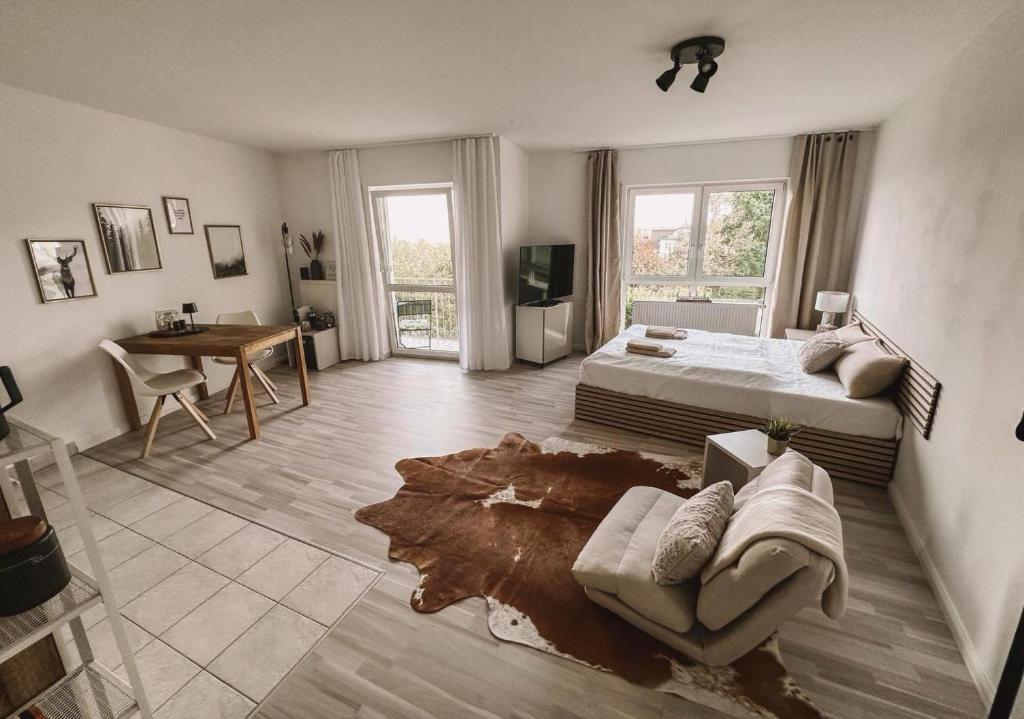 a bedroom with a bed and a couch and a table at Ferienwohnung am Reißberg in Plauen