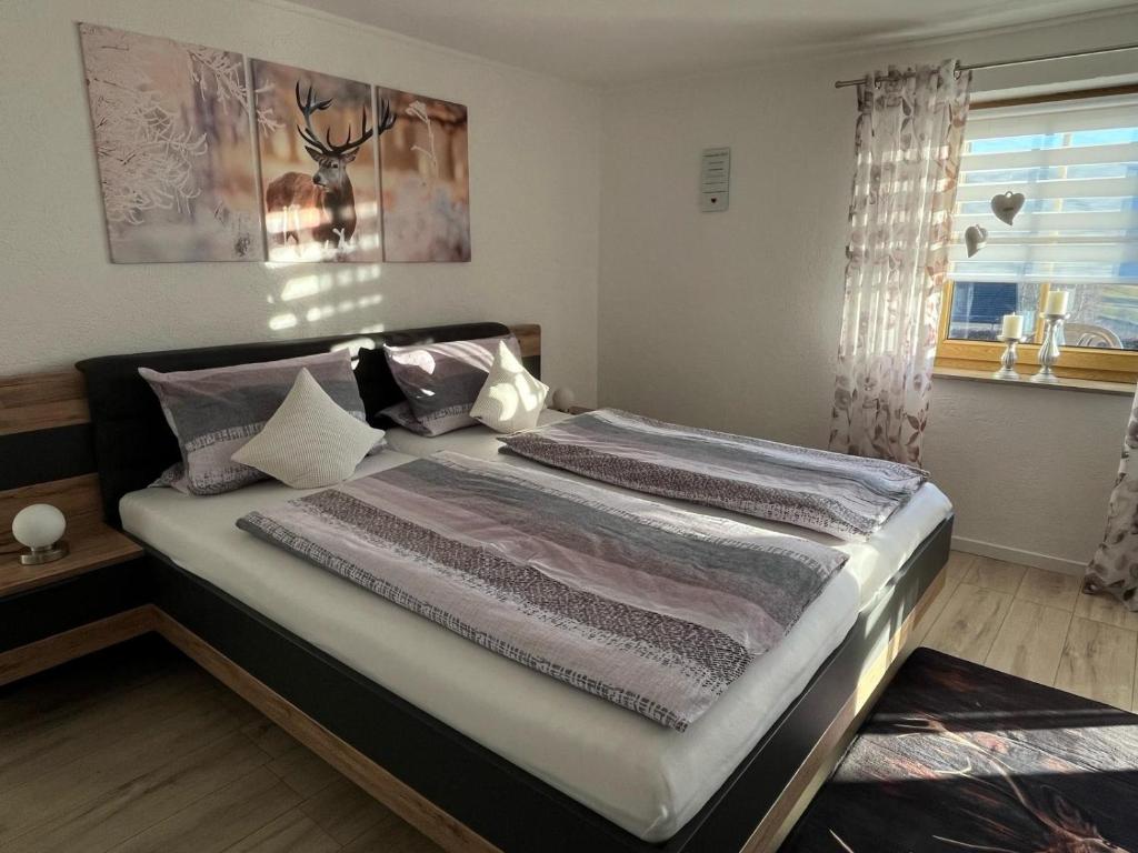 a large bed in a bedroom with a window at Ferienwohnung Köppl in Lam