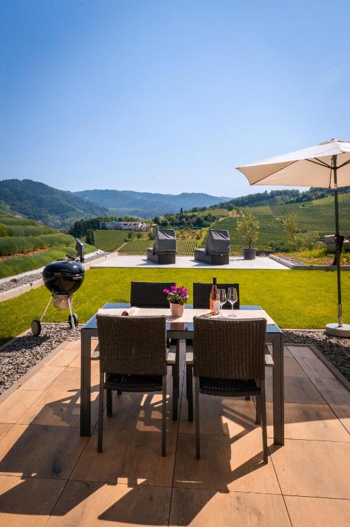 a table with chairs and an umbrella on a patio at Corner 28 in Oberkirch
