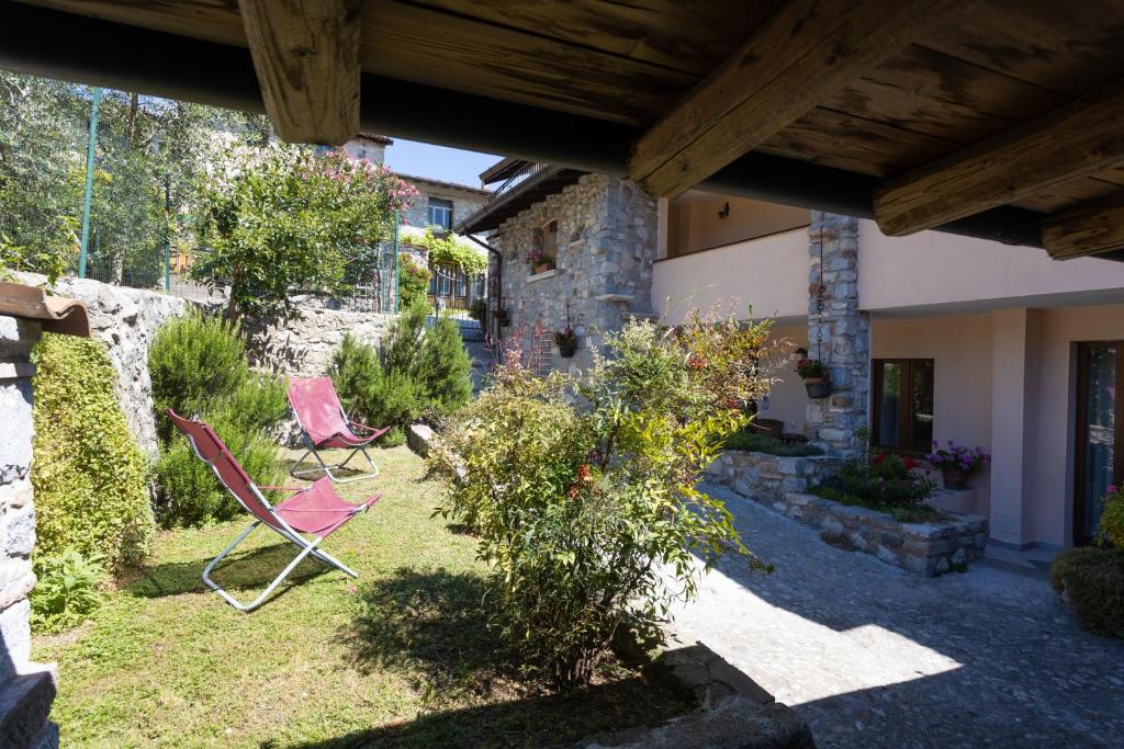 two chairs in the yard of a house at Casa Rita app 4 in Tremosine Sul Garda