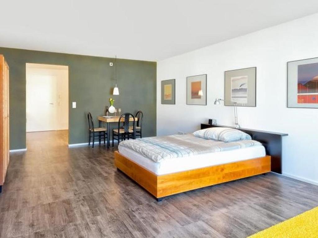 a bedroom with a bed and a dining room at Hochburger 21 in Emmendingen