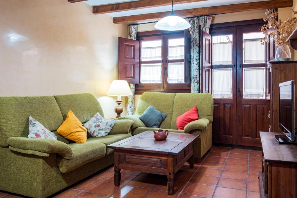 a living room with two couches and a coffee table at Las Puentes 1 in Candelario