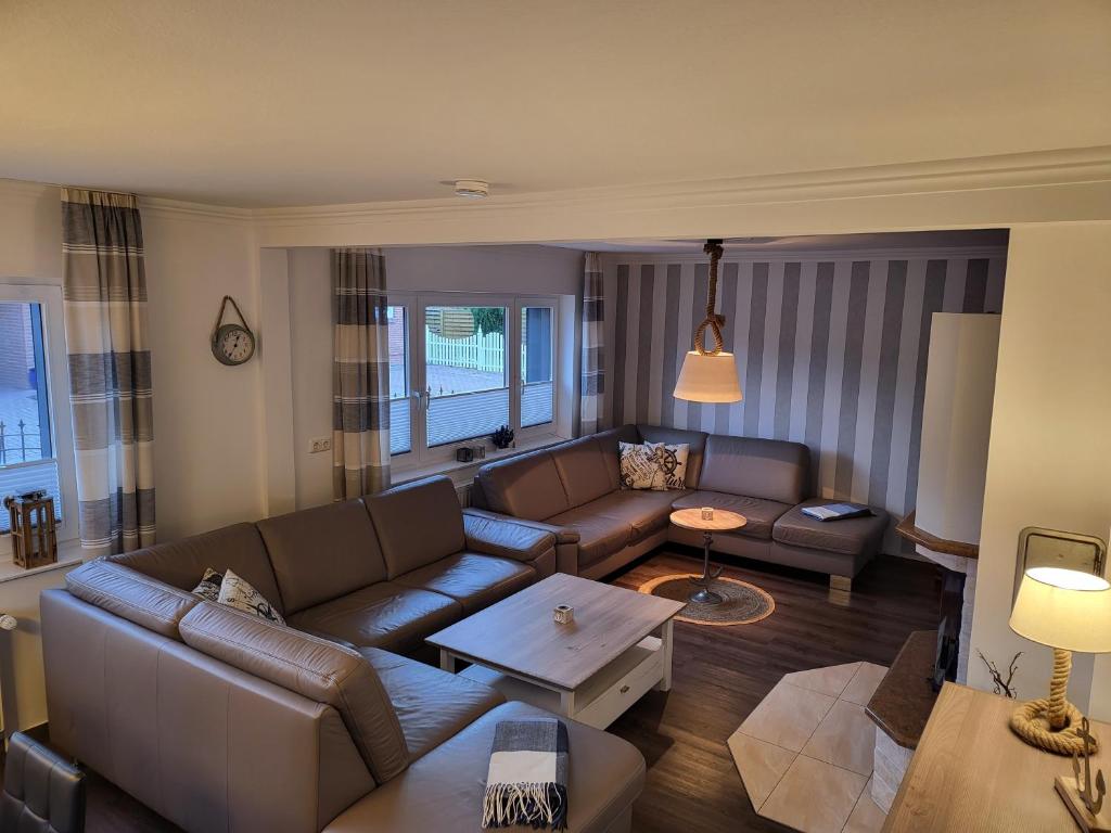 a living room with a couch and a table at Anker Perla in Grömitz