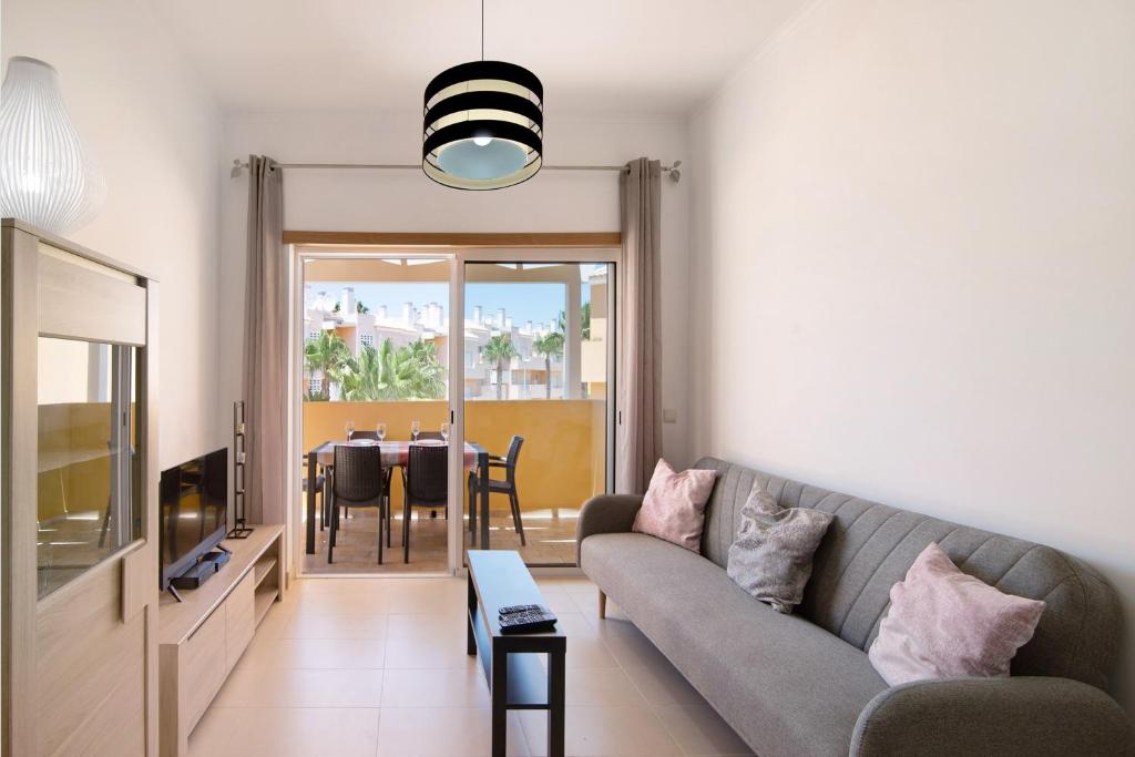 a living room with a couch and a table at Royal Cabanas Golf 89 in Cabanas de Tavira