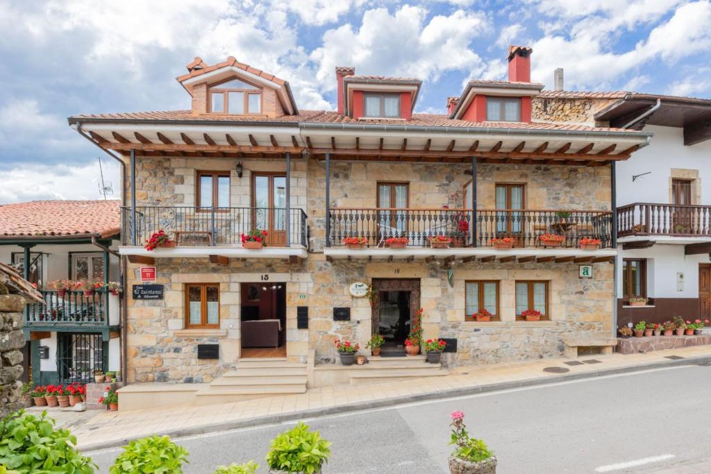 an old stone house with balconies on a street at Quintanal de Villacarriedo in Villacarriedo