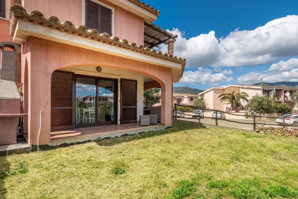 a house with a patio and a yard at villa Isabel 2 in Villasimius