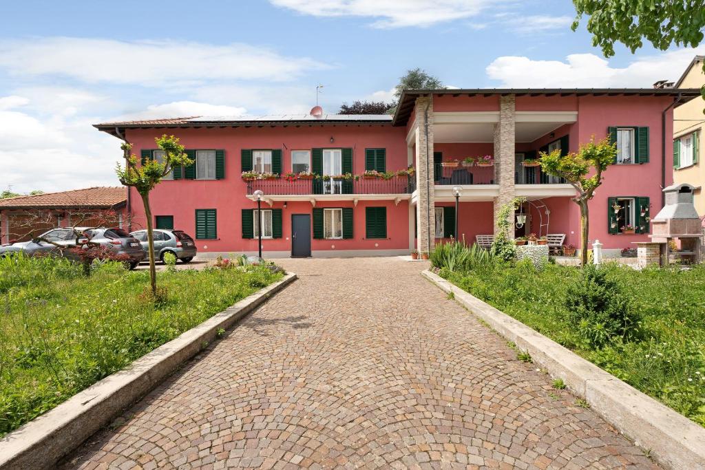 a red building with a brick road in front of it at Al Vecchio Pozzo in Brebbia