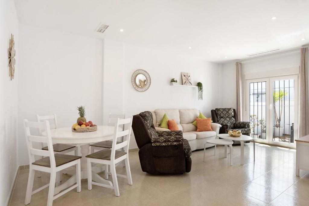 a living room with a couch and a table at Casa Noria in Vejer de la Frontera