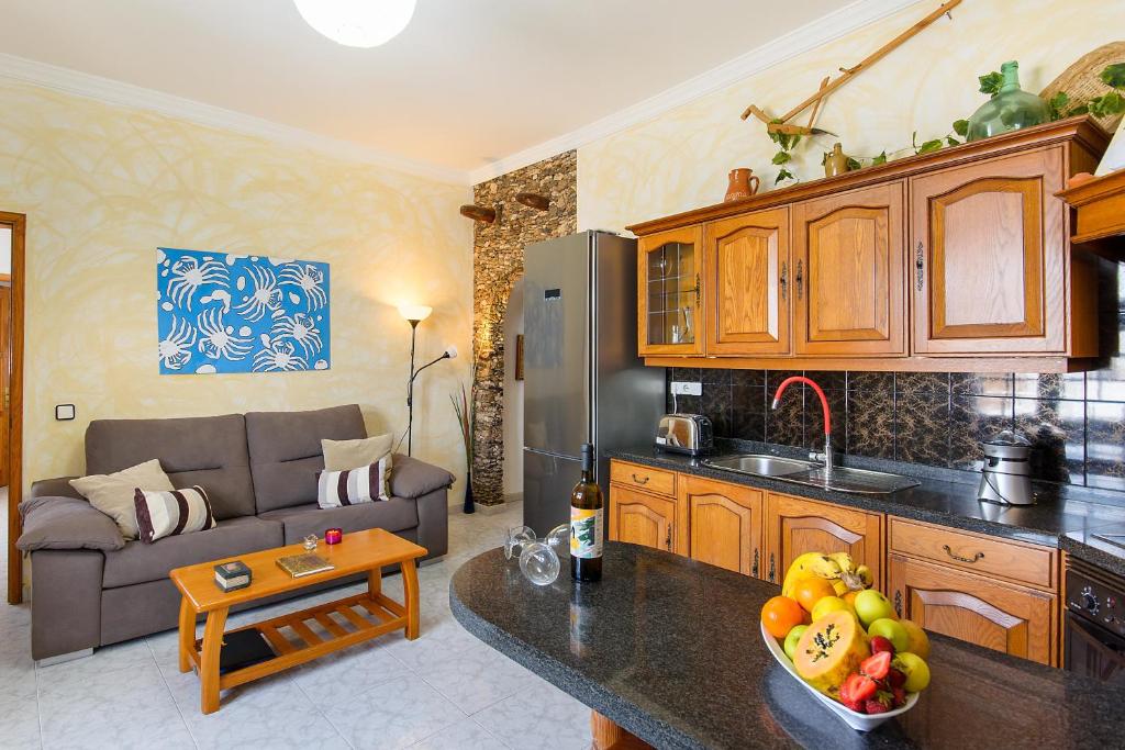 a kitchen and a living room with a couch at El Golfo Lanzarote in El Golfo