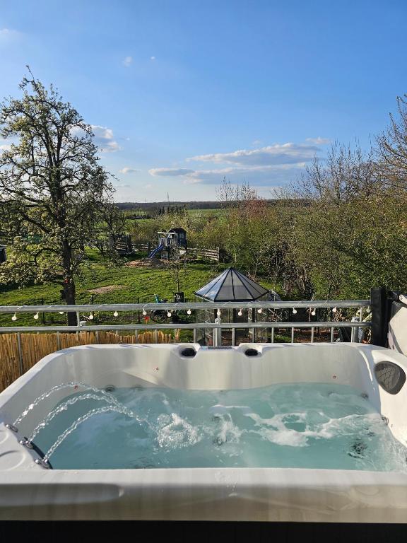 a jacuzzi tub with a view of a field at Wohlfühloase nähe Messe in Sehnde
