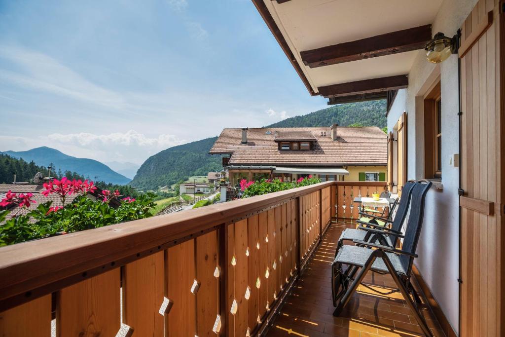 a balcony with chairs and a view of mountains at Appartements Gabrielli Anna in Trodena