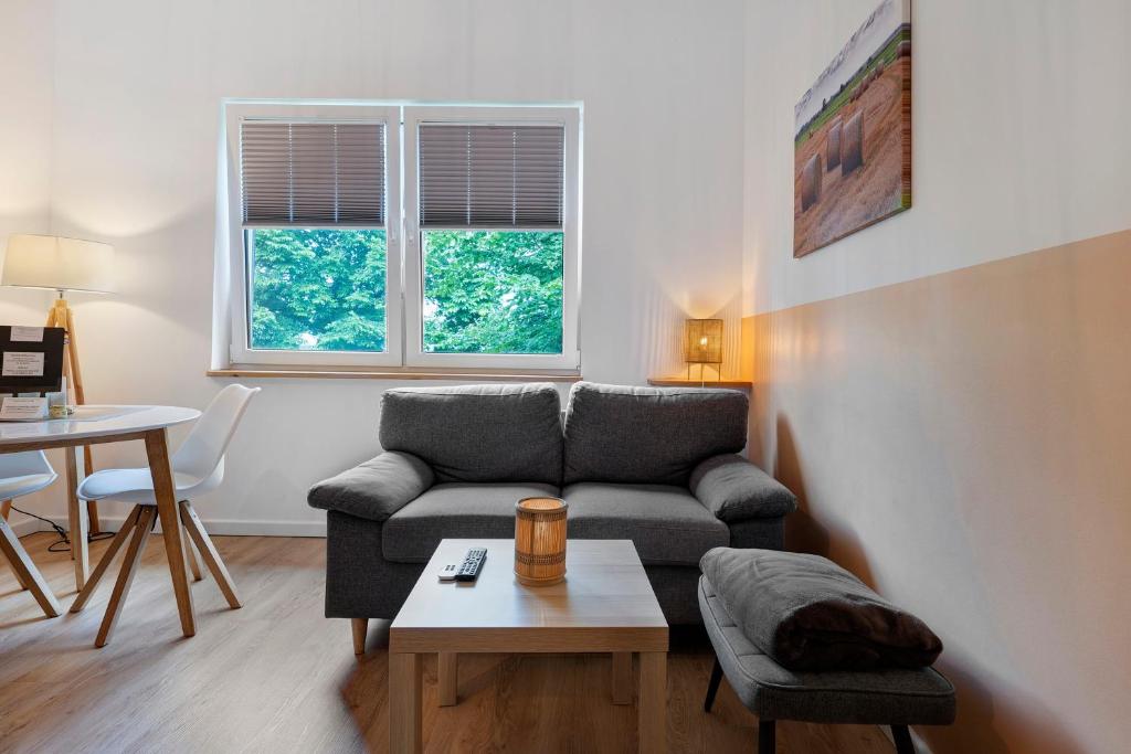 a living room with a couch and a table at Ferienwohnung Junge 4 in Lohe-Rickelshof