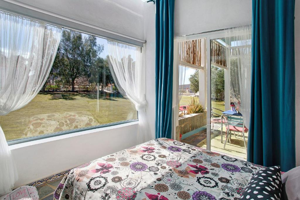 a bedroom with a bed and a large window at Finca Fani 3 in Agüimes