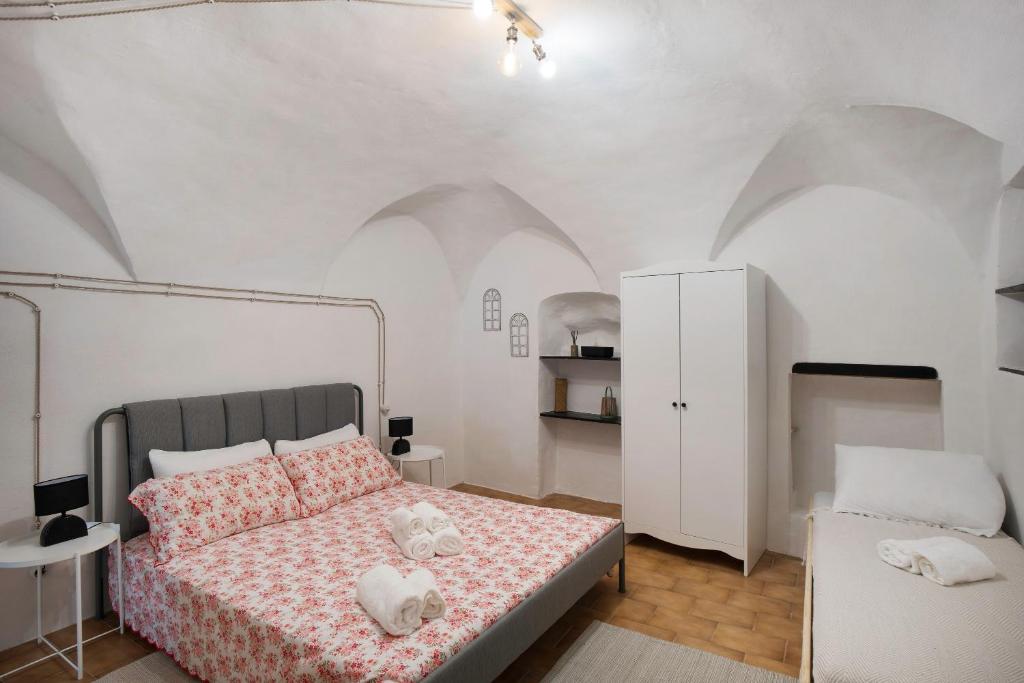 a bedroom with a bed with two stuffed animals on it at Casetta l'Ulivo in Poggi