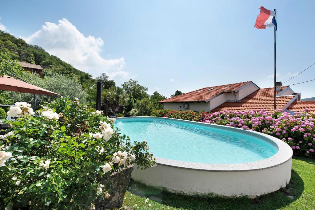 a swimming pool in the yard of a house at Barcollo House - Piscina nel verde in Stella
