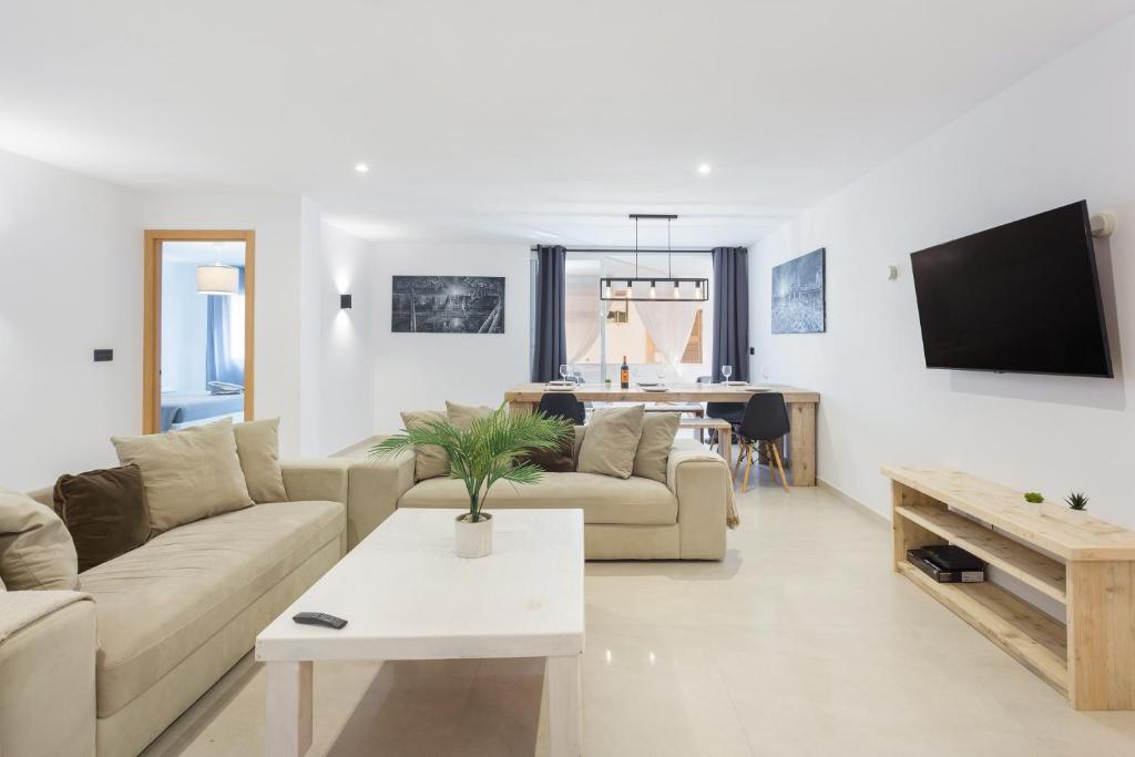 a living room with a couch and a tv at Lujoso cerca de playa in Jávea